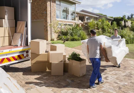 Friends organizing personal belongings and cardboard boxes during a residential relocation covering various Types of Moving