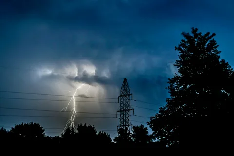 Severe electrical equipment explosion and utility line failure at night representing severe Power Outages Causes