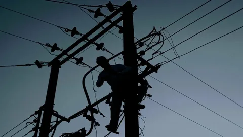 Electrical substation explosion glowing with bright blue arcs during a storm, illustrating major Power Outages Causes