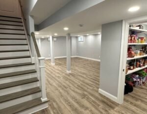 A remodeled basement featuring stairs leading to a pantry, showcasing modern design and functional space.