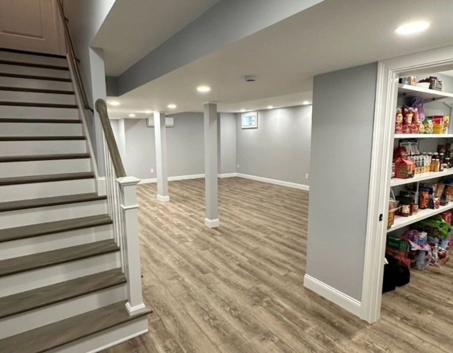 A remodeled basement featuring stairs leading to a pantry, showcasing modern design and functional space.