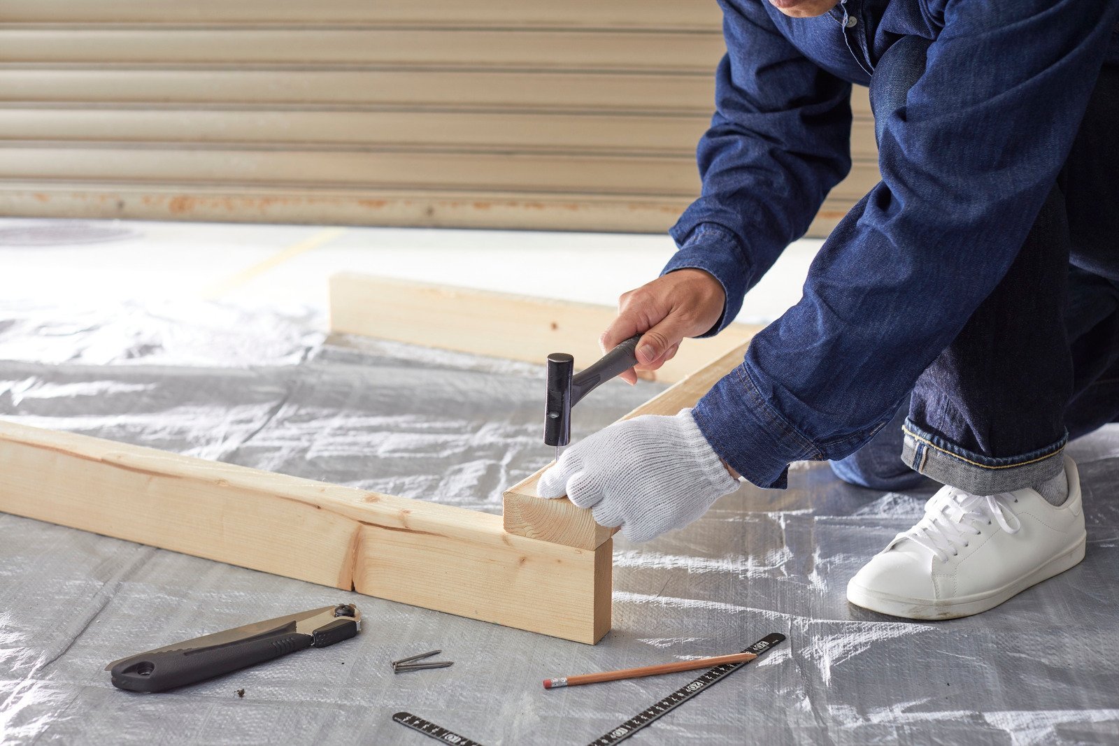 canva carpenter assembling wooden frame with hammer MAGcuBYjbMg