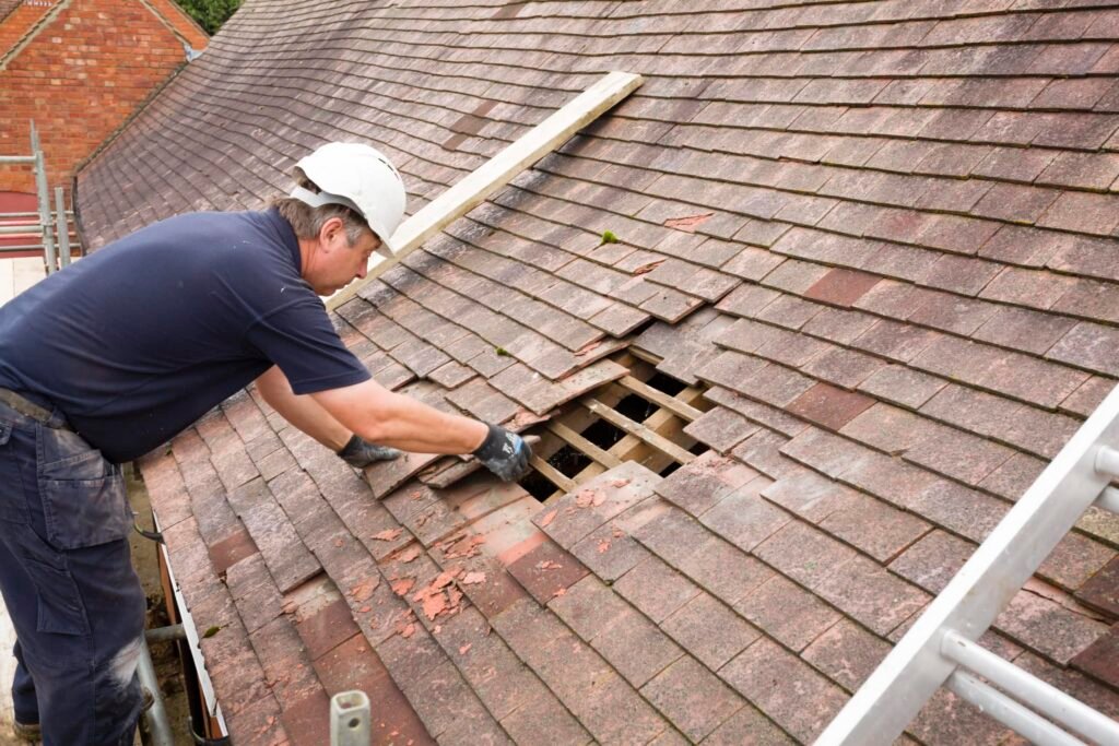 Affordable Roofing Contractor in Hollywood, FL – Quality You Can Rely On 1 A roofing contractor working on a roof, using a ladder for access and safety.