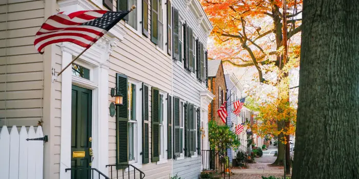 Compare mortgage rates in Virginia, Picture is shwoing an american street with amercian flags on buildings.