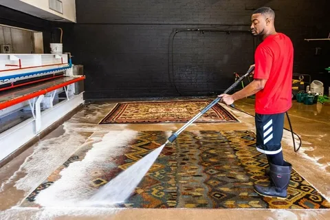 How Does Professional Carpet Cleaning Work? 2 Certified technician in uniform cleaning a living room floor with advanced equipment, showcasing reliable Professional Carpet Cleaning
