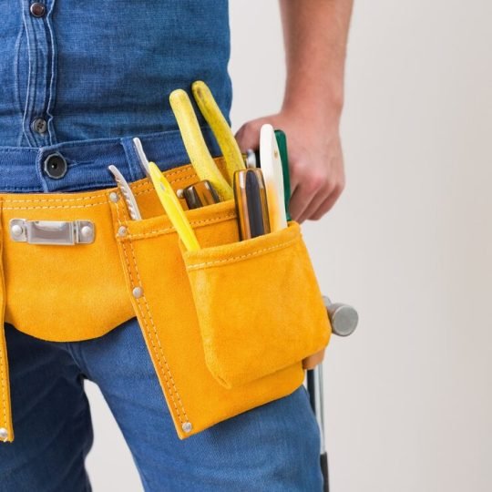 mid-section-handyman-with-toolbelt_13339-67956